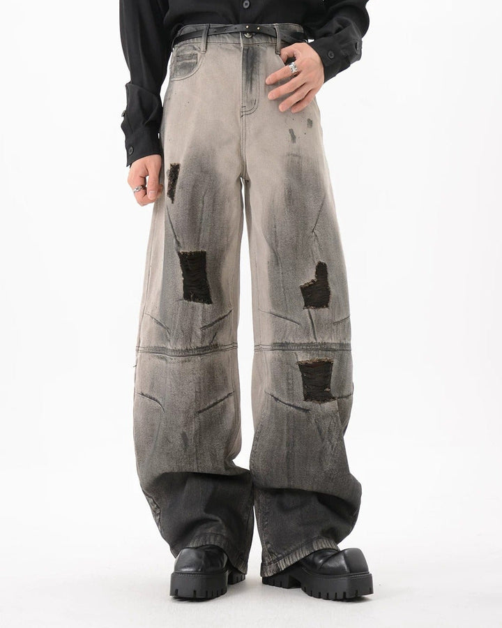 Close-up detail of Black Patch Distressed Baggy Jeans