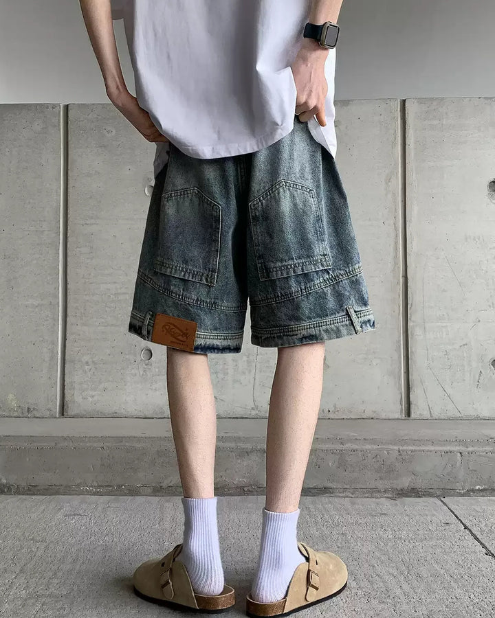 Vintage-wash wide-leg denim shorts, blue, back showing rear pockets and hem patch