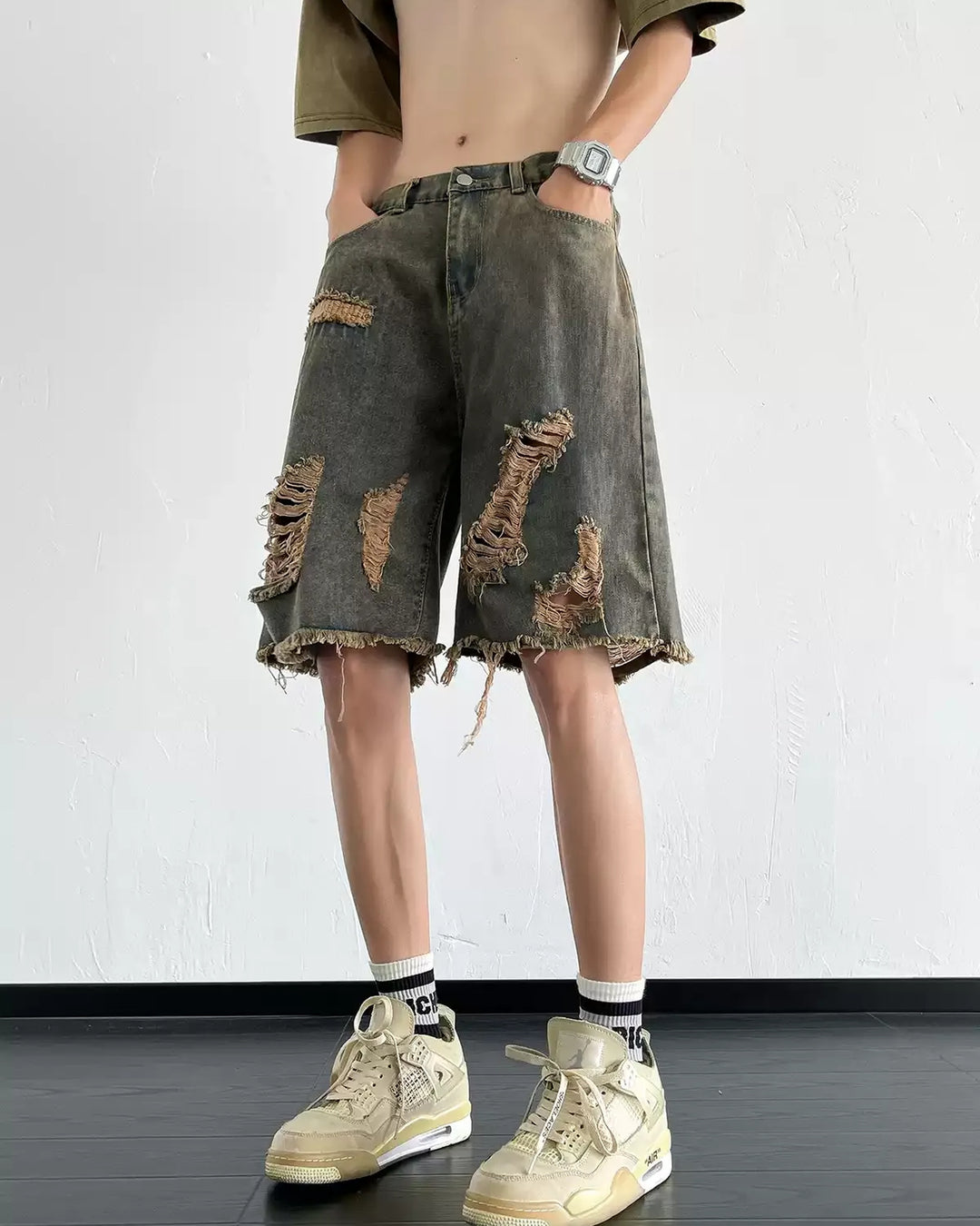 Dark washed heavy-ripped denim shorts, front with waistband visible