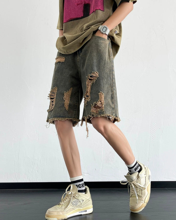 Dark washed heavy-ripped denim shorts, angled front with wide legs