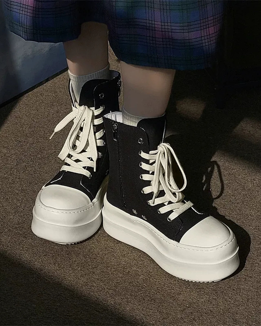 Close-up sole detail of Black and White High-Top Minimalist Shoes
