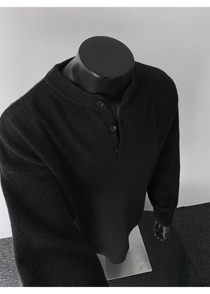Stand-collar button knit sweater, angled view of the black sweater