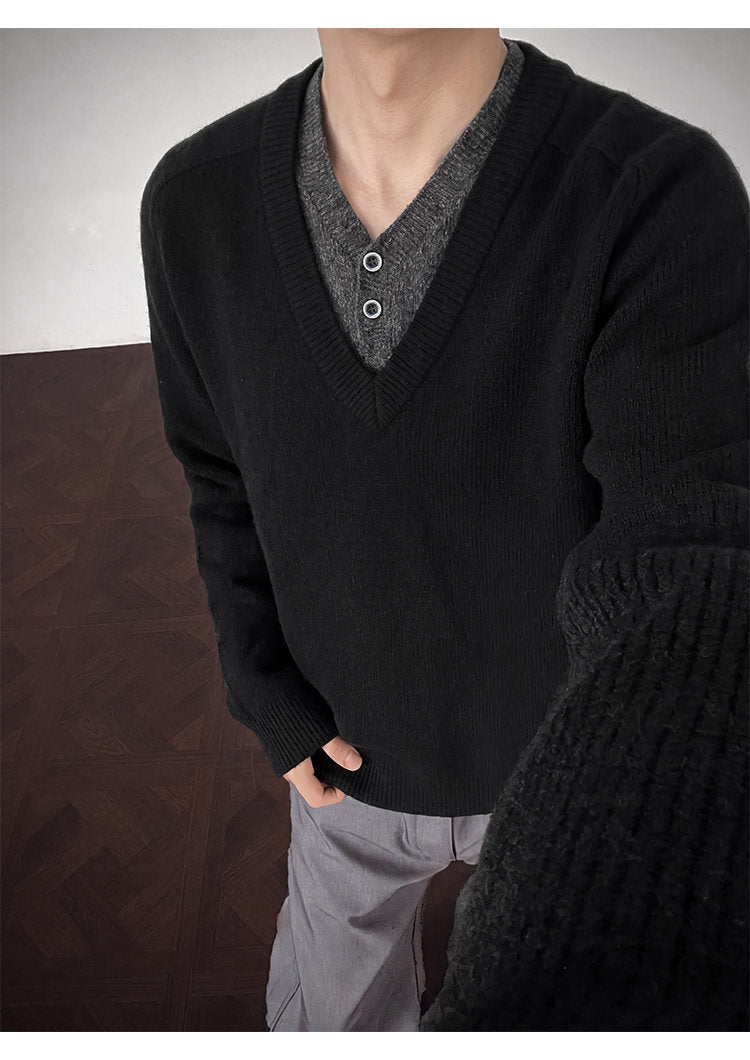 Layered V-neck knit sweater, close-up view of the black neckline
