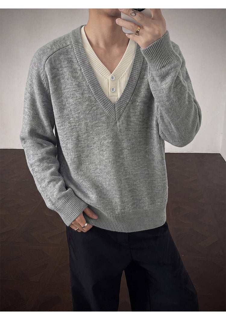 Layered V-neck knit sweater, angled view of the gray sweater
