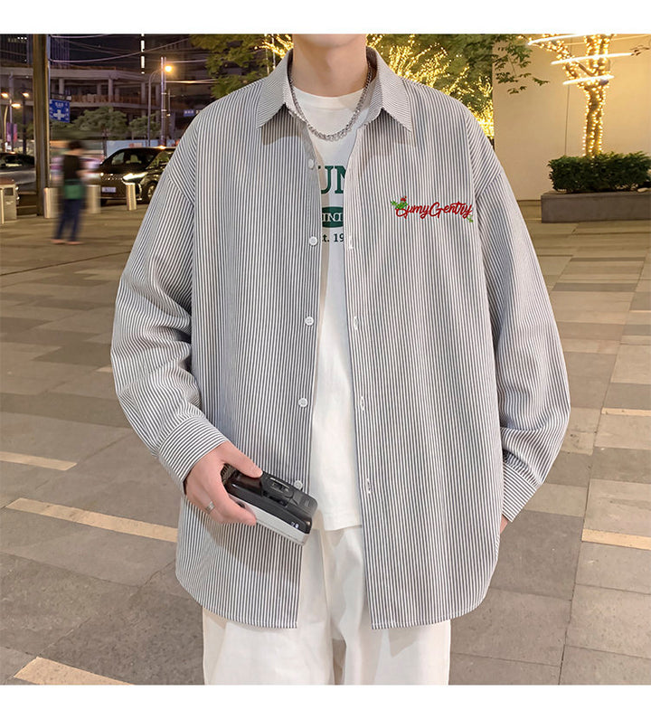 Letter-embroidered shirt, front view showing the oversized fit