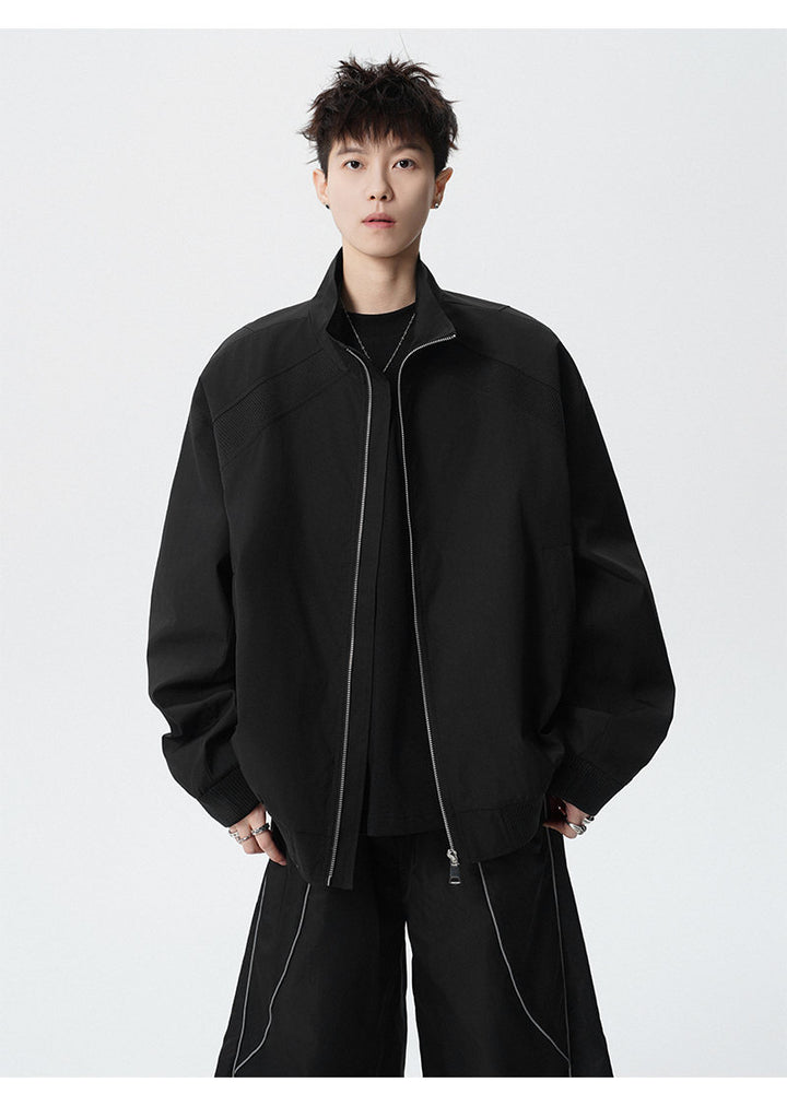 Paneled stand-collar jacket, angled view of the black jacket