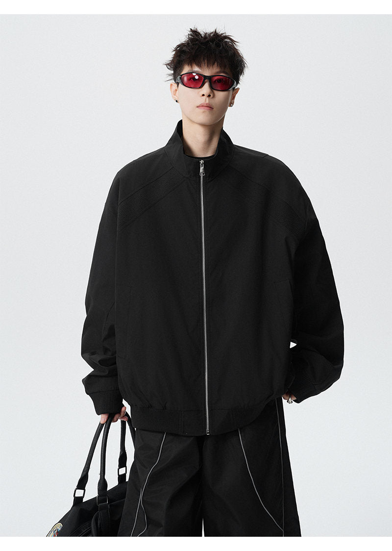 Paneled stand-collar jacket, front view of the black paneled jacket