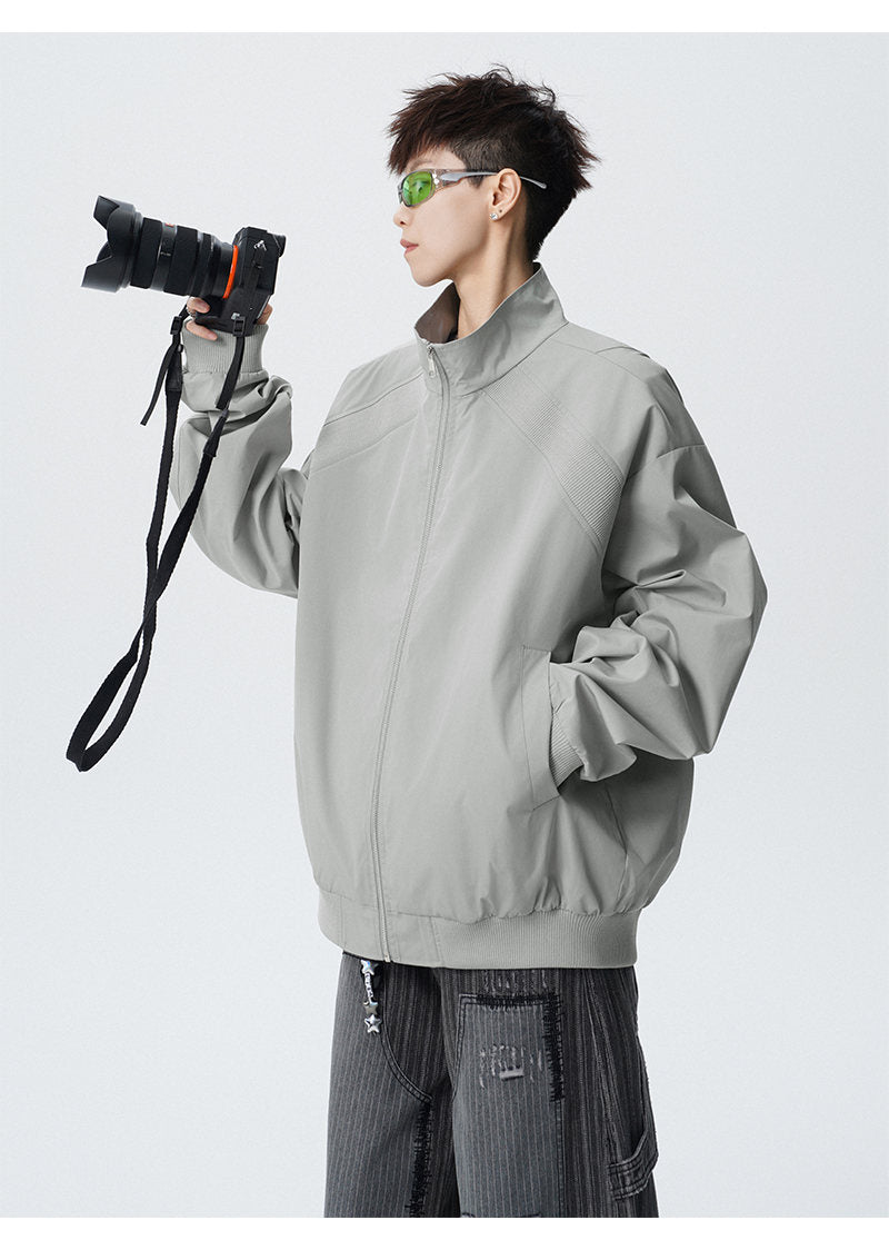 Paneled stand-collar jacket, angled view of the gray jacket
