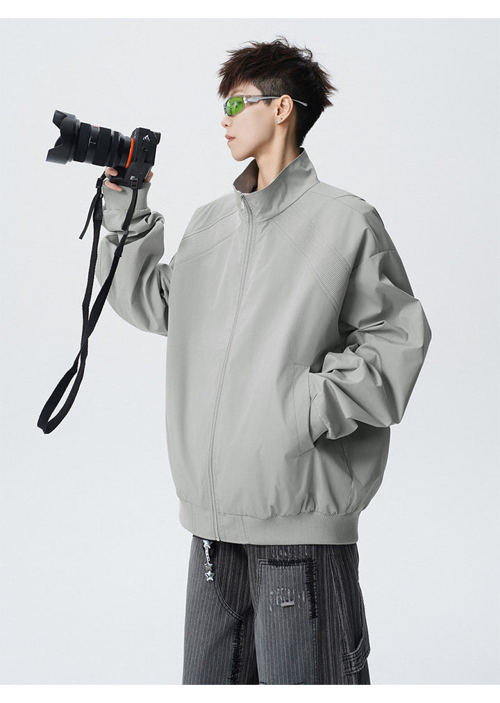 Paneled stand-collar jacket, angled view of the gray jacket