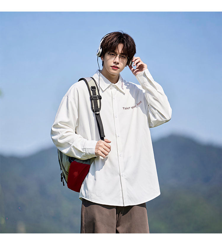 Script-embroidered shirt, angled view of the white shirt