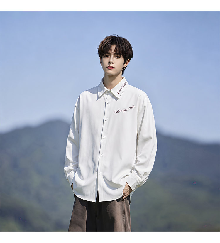 Script-embroidered shirt, front view of the white shirt