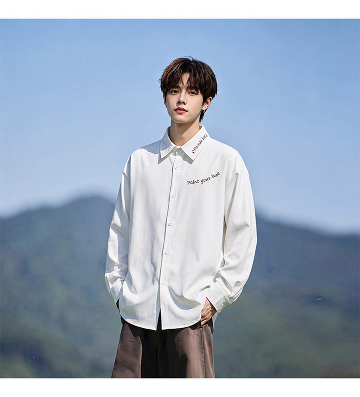 Script-embroidered shirt, front view of the white shirt