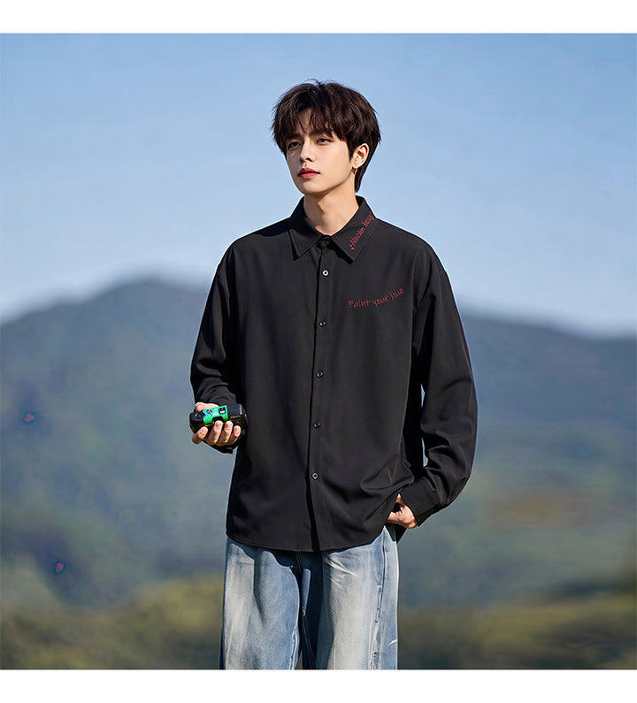 Script-embroidered shirt, front view of the black shirt